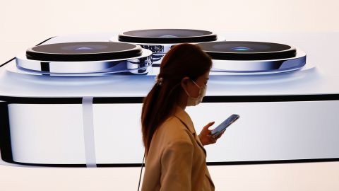 A woman walks past an image of an iPhone 13 Pro at an Apple Store on the day the new Apple iPhone 13 series went on sale, in Beijing, China, on September 24, 2021. 