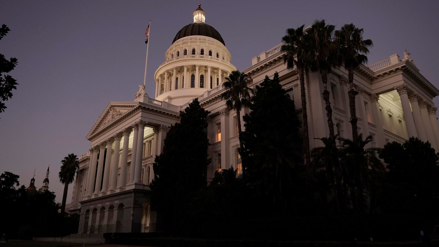 The lights of the California state Capitol glow into the night in Sacramento, August 31, 2022
