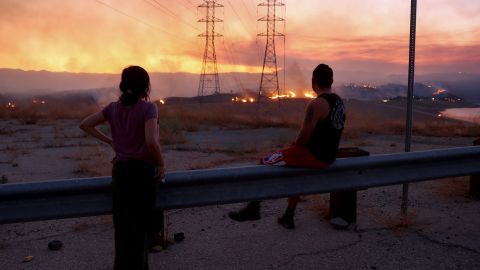 Residents who were evacuated from their home watch as the Route Fire burns on August 31, 2022 near Castaic, California. 
