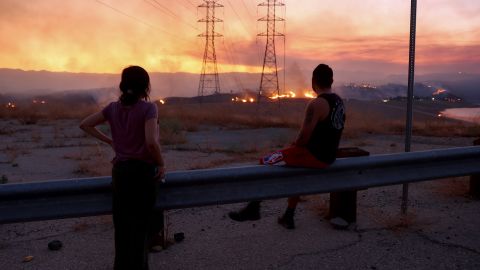 Residents who were evacuated from their home watch as the Route Fire burns on August 31, 2022 near Castaic, California.