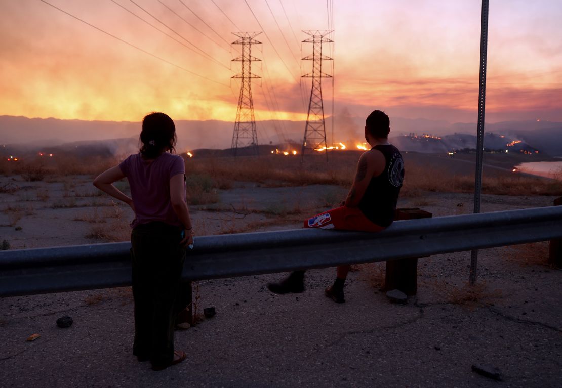 Residents who were evacuated from their home watch as the Route Fire burns on August 31, 2022 near Castaic, California. 