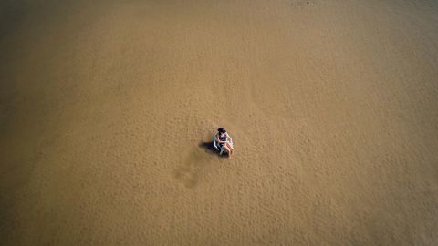 A visitor cools off in the shallow waters of the Danube River near Novi Sad, Serbia, on Monday, August 29. Europe's drought has left parts of the Danube shriveled.