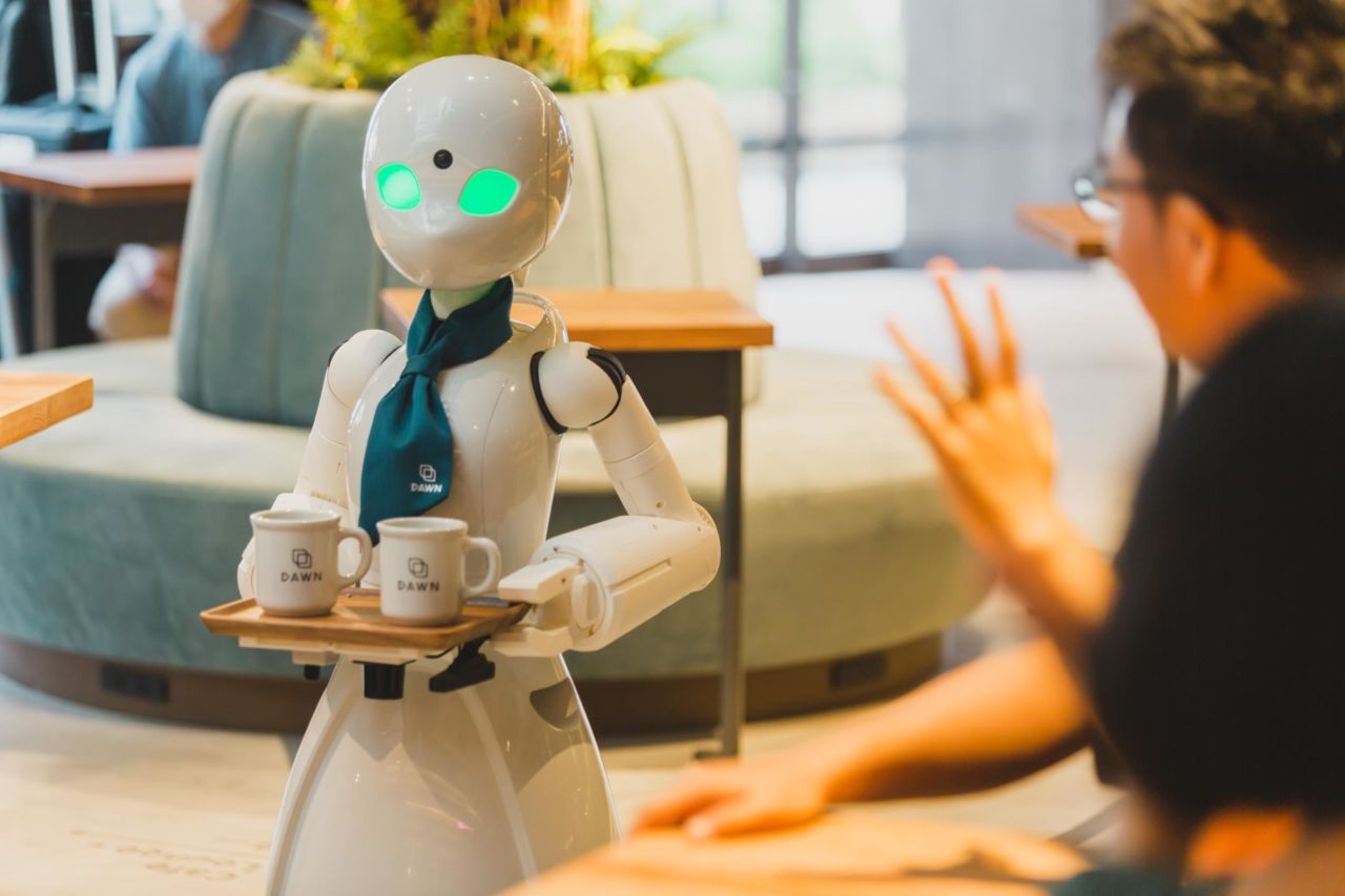 <strong>Service with a cyborg: </strong>At the <a href="https://dawn2021.orylab.com/en/" target="_blank" target="_blank">DAWN Avatar Robot Cafe in Tokyo</a>, Japan, robots are not autonomous but are controlled remotely by people who struggle in conventional jobs because of disabilities or lifestyle constraints. The wheelchair accessible cafe strives for inclusivity, and currently has 70 "pilots" who control the barista robot and server robot (pictured) from home or hospital.