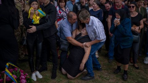 Olga Gregorievna Styglyuk faints during her son's funeral in Bucha, Ukraine, on Wednesday, August 31. Yury Styglyuk was a Ukrainian serviceman who died in combat.