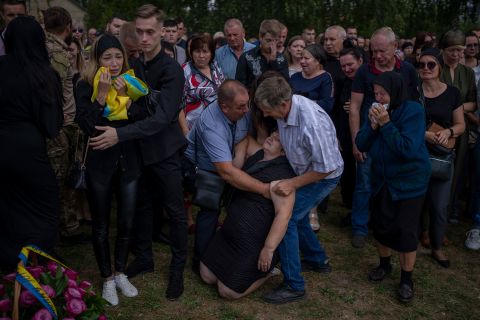 Olga Gregorievna Styglyuk faints during her son's funeral in Bucha, Ukraine, on Wednesday, August 31. Yury Styglyuk was a Ukrainian serviceman who died in combat.