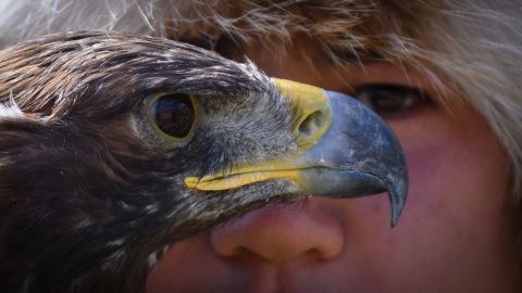 A man holds his golden eagle during a hunting festival outside Bishkek, Kyrgyzstan, on Monday, August 29.