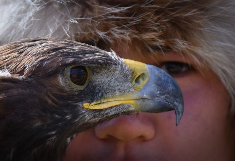 A man holds his golden eagle during a hunting festival outside Bishkek, Kyrgyzstan, on Monday, August 29.