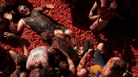 Revelers are covered in tomato pulp while participating the annual Tomatina festival in Buñol, Spain, on Wednesday, August 31. <a href="https://www.cnn.com/videos/world/2022/08/31/tomato-food-fight-spain-orig-dp.cnn" target="_blank">The "world's largest food fight"</a> was in its 75th year.