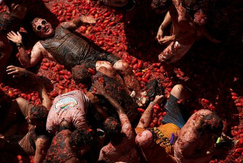 Revelers are covered in tomato pulp while participating the annual Tomatina festival in Buñol, Spain, on Wednesday, August 31. <a href=