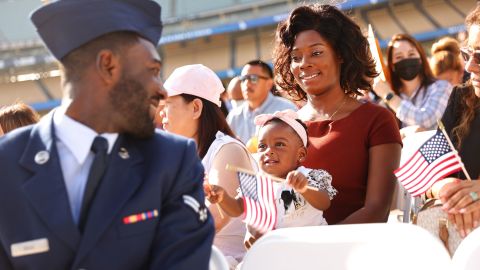 US Air Force Airman Michael Drah, originally from Ghana, looks back at his wife, Akosua, and his daughter Rashana before he officially became a US citizen on Monday, August 29. The naturalization ceremony was held at Dodger Stadium in Los Angeles.