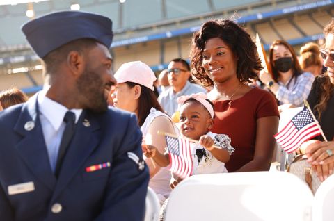 US Air Force Airman Michael Drah, originally from Ghana, looks back at his wife, Akosua, and his daughter Rashana before he officially became a US citizen on Monday, August 29. The naturalization ceremony was held at Dodger Stadium in Los Angeles.