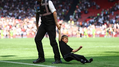 A young pitch invader is removed by a steward after a Premier League match in Southampton, England, on Saturday, August 27.