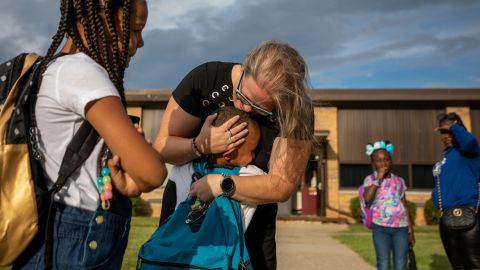 Kindergarten teacher Stephanie Cleland gives a hug to a former student at Daly Elementary School in Inkster, Michigan, on Monday, August 29. It was the first day of school.