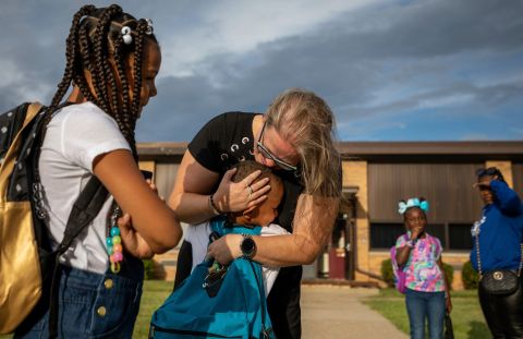 Kindergarten teacher Stephanie Cleland gives a hug to a former student at Daly Elementary School in Inkster, Michigan, on Monday, August 29. It was the first day of school.