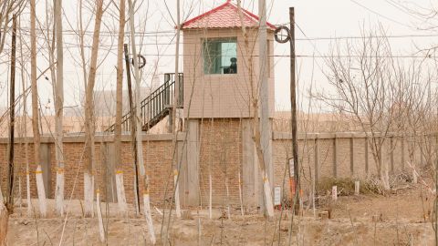 A security guard watches from a tower around a detention facility in Yarkent County in northwestern China's Xinjiang region on March 21, 2021. 