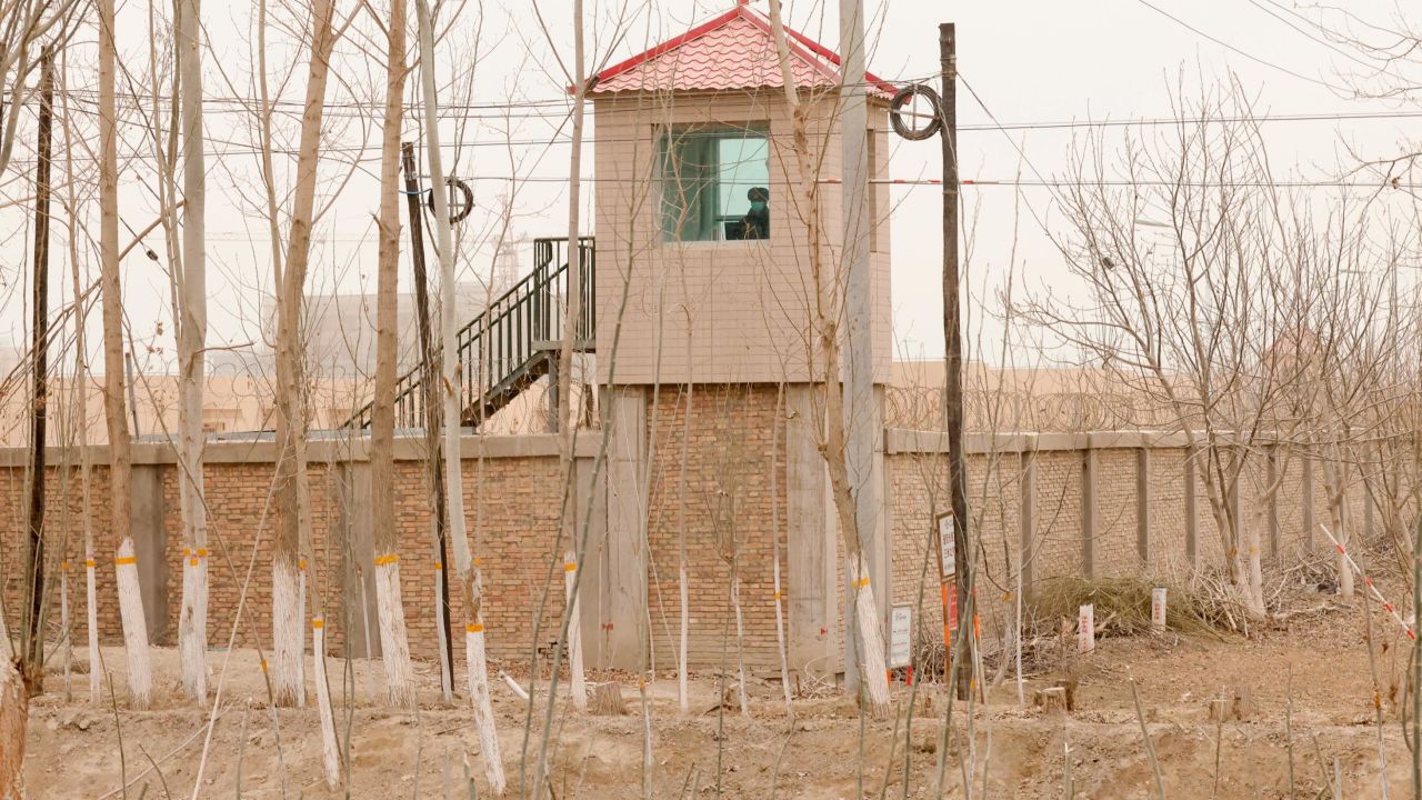 A security guard watches from a tower around a detention facility in Yarkent County in northwestern China's Xinjiang region on March 21, 2021.