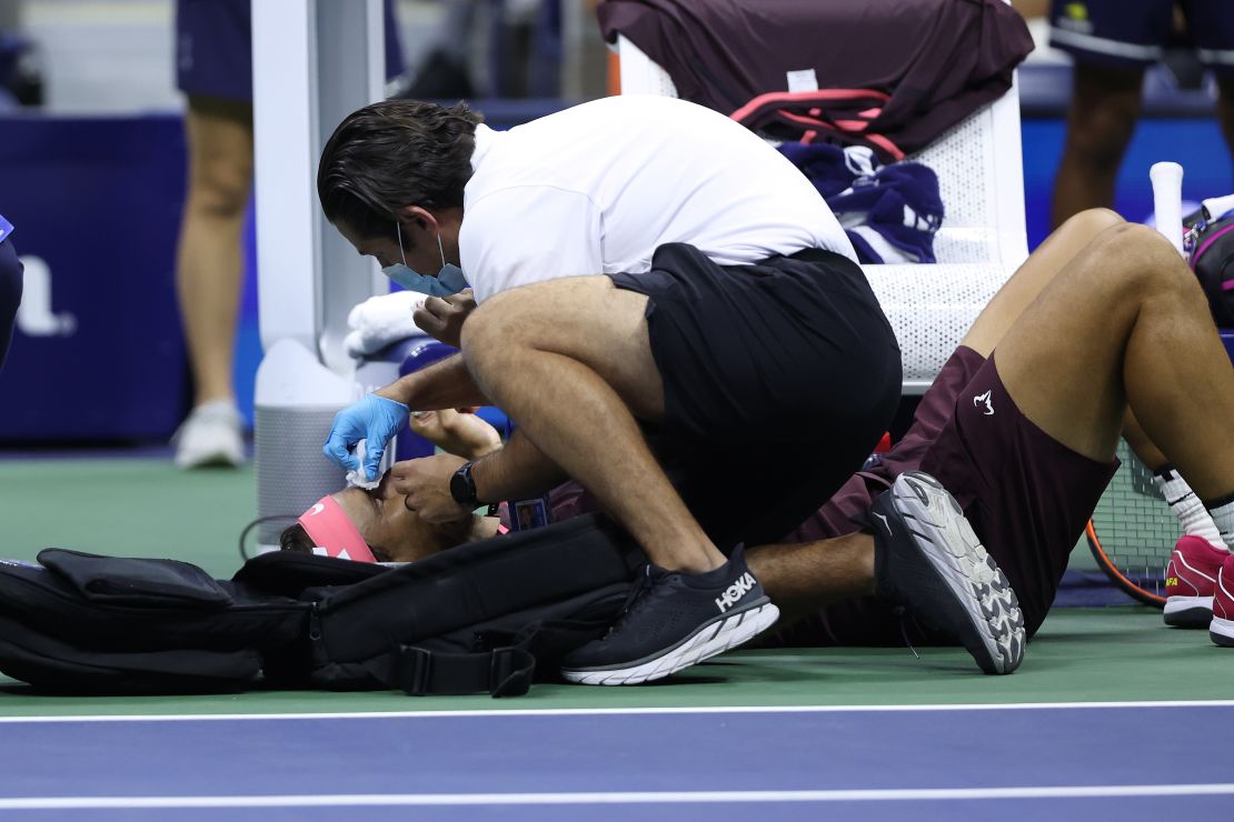 Nadal receives medical attention after accidentally hitting himself in the head with his racket.