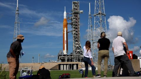 Photographers and reporters work near NASA's Artemis I rocket  at Kennedy Space Center on Monday. A range of issues prevented liftoff then.