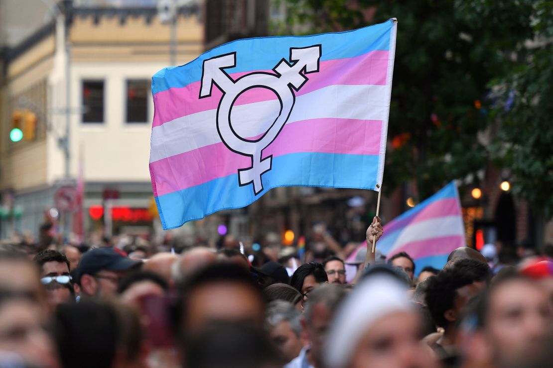 A person holds a transgender pride flag on June 28, 2019 at a rally marking the 50th anniversary of the Stonewall Riots in New York.
