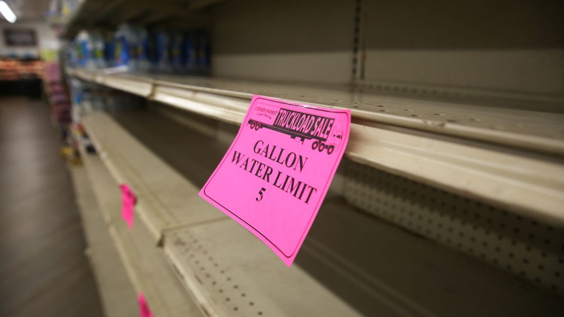 A sign limiting water purchases is seen on an empty shelf at a Corner Market in Jackson, Mississippi, on August 30.