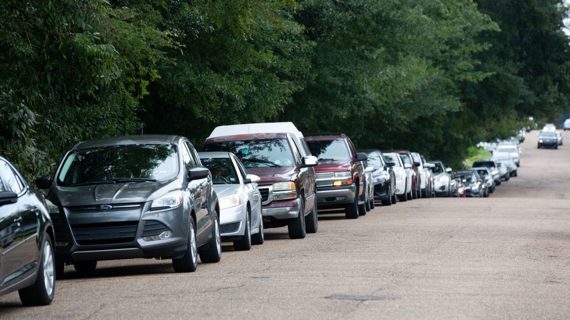 Cars line up at a water distribution site at Grove Park Community Center in Jackson, Mississippi, on August 31.
