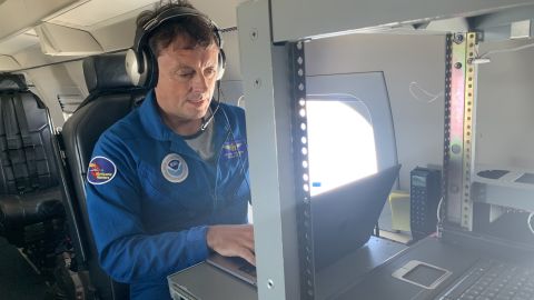Jason Dunion analyzes real-time data from a disturbance near Cape Verde while on the hurricane hunter aircraft flies through the storm.