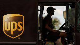 A UPS delivery van is driven long a city street in Garden Grove, California, U.S., March 29, 2022.   