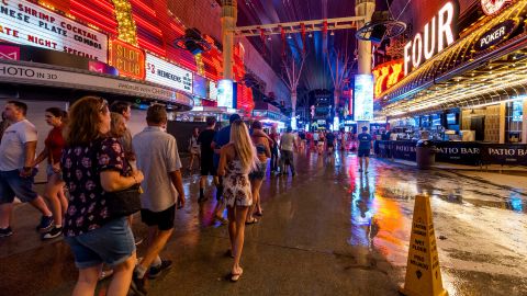 People navigate the rainy walkways at the Fremont Street Experience in Las Vegas during a storm in late July.