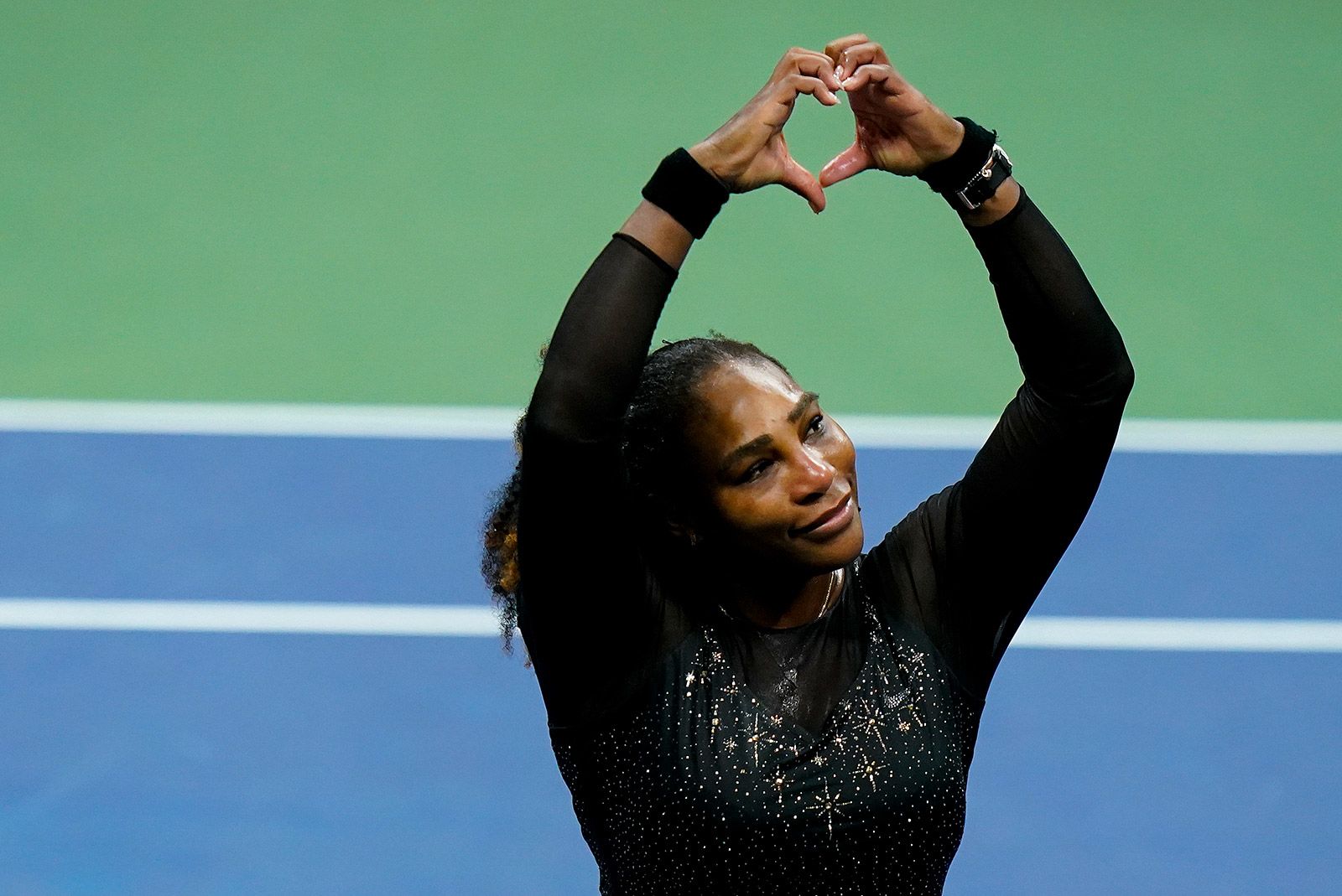 Williams motions a heart to her fans after the match.