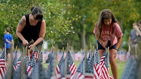 Volunteers in Framingham, Massachusetts plant flags honoring 9/11 victims in 2021.