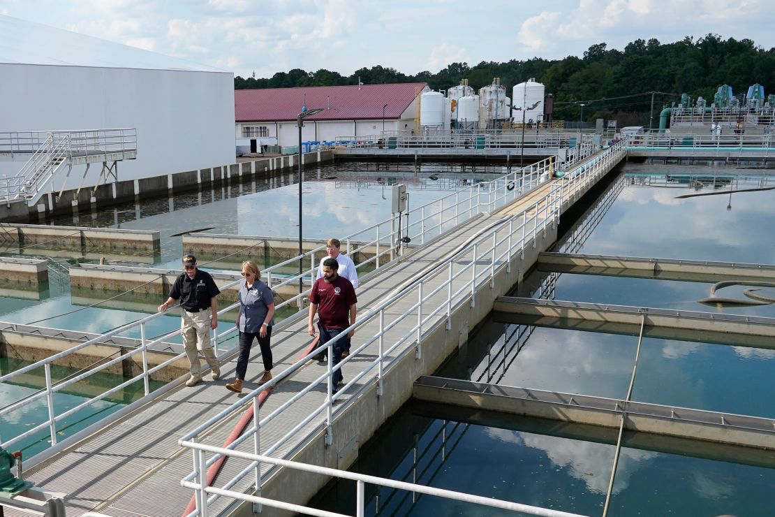 Jim Craig of the Mississippi State Department of Health, left, leads FEMA Administrator Deanne Criswell, center; Jackson Mayor Chokwe Antar Lumumba, right; and Gov. Tate Reeves, rear, as they walk past basins at the O.B. Curtis Water Treatment Facility in Ridgeland on Friday.