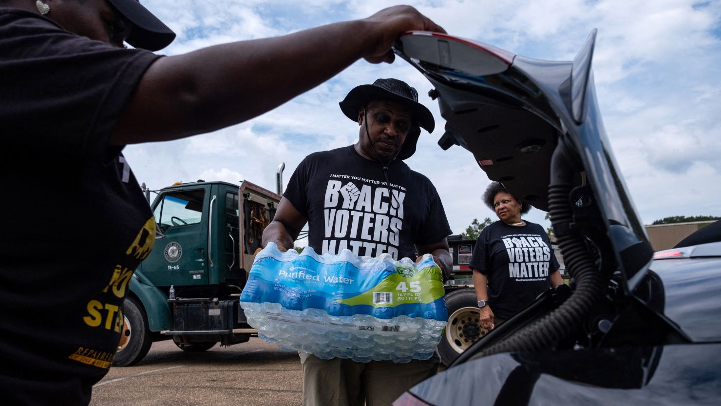 Residents distribute cases of water last September in Jackson, Mississippi.
