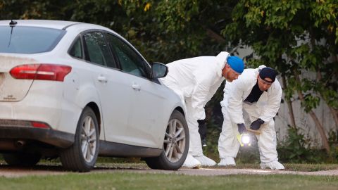 A police forensic team investigates a crime scene in the stabbing madness that resulted in 10 deaths. 