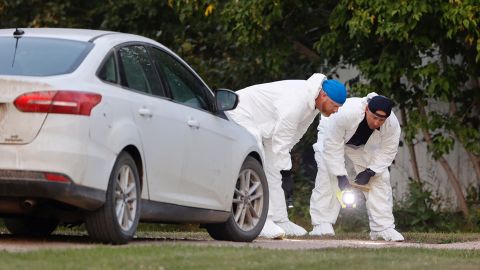 A police forensics team investigates a crime scene in the stabbing spree that left 10 dead.