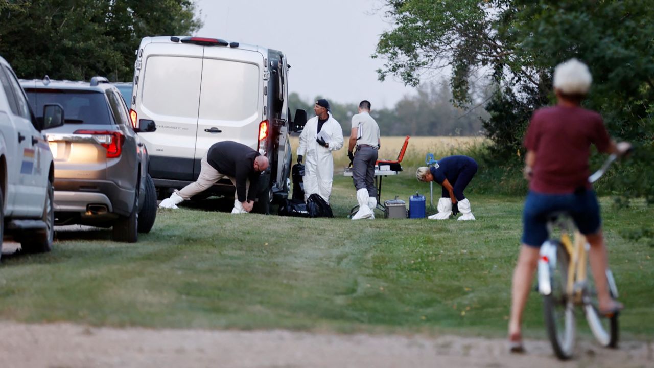 A police forensics team investigates a crime scene after multiple people were killed last month in Saskatchewan, Canada.