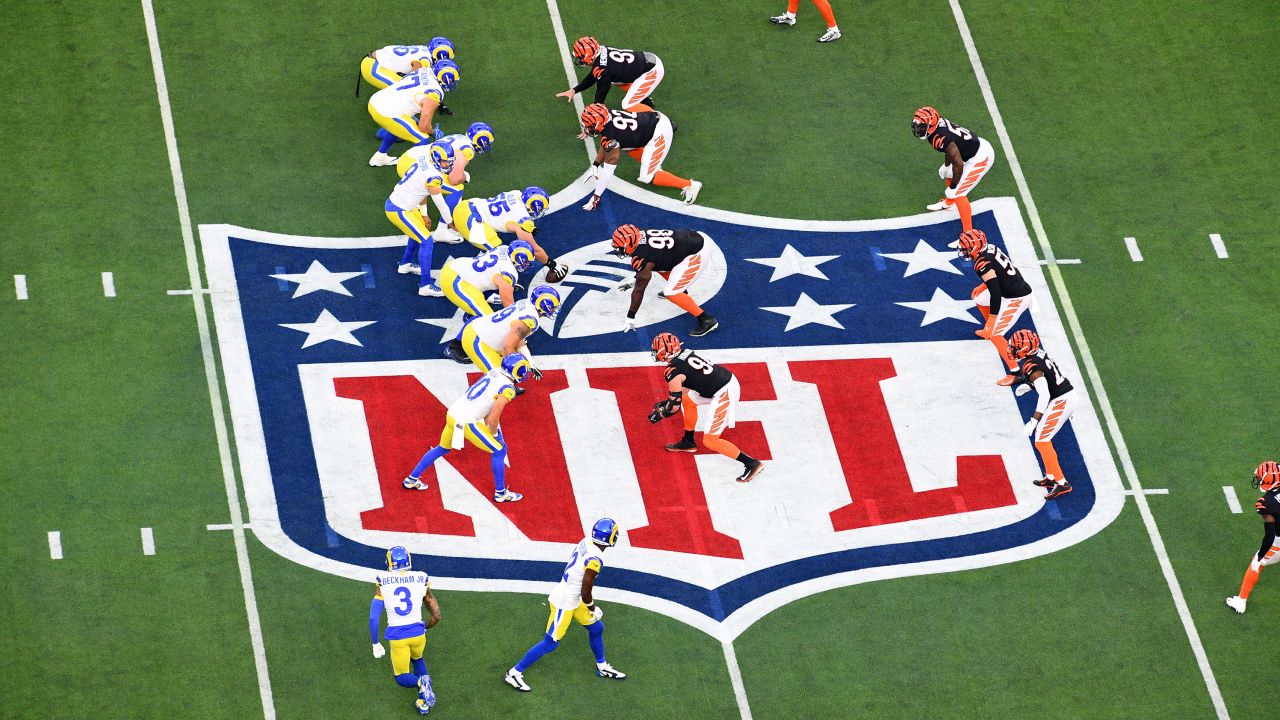 The Los Angeles Rams and Cincinnati Bengals line up over the NFL logo in the first half during Super Bowl LVI on February 13 at SoFi Stadium.