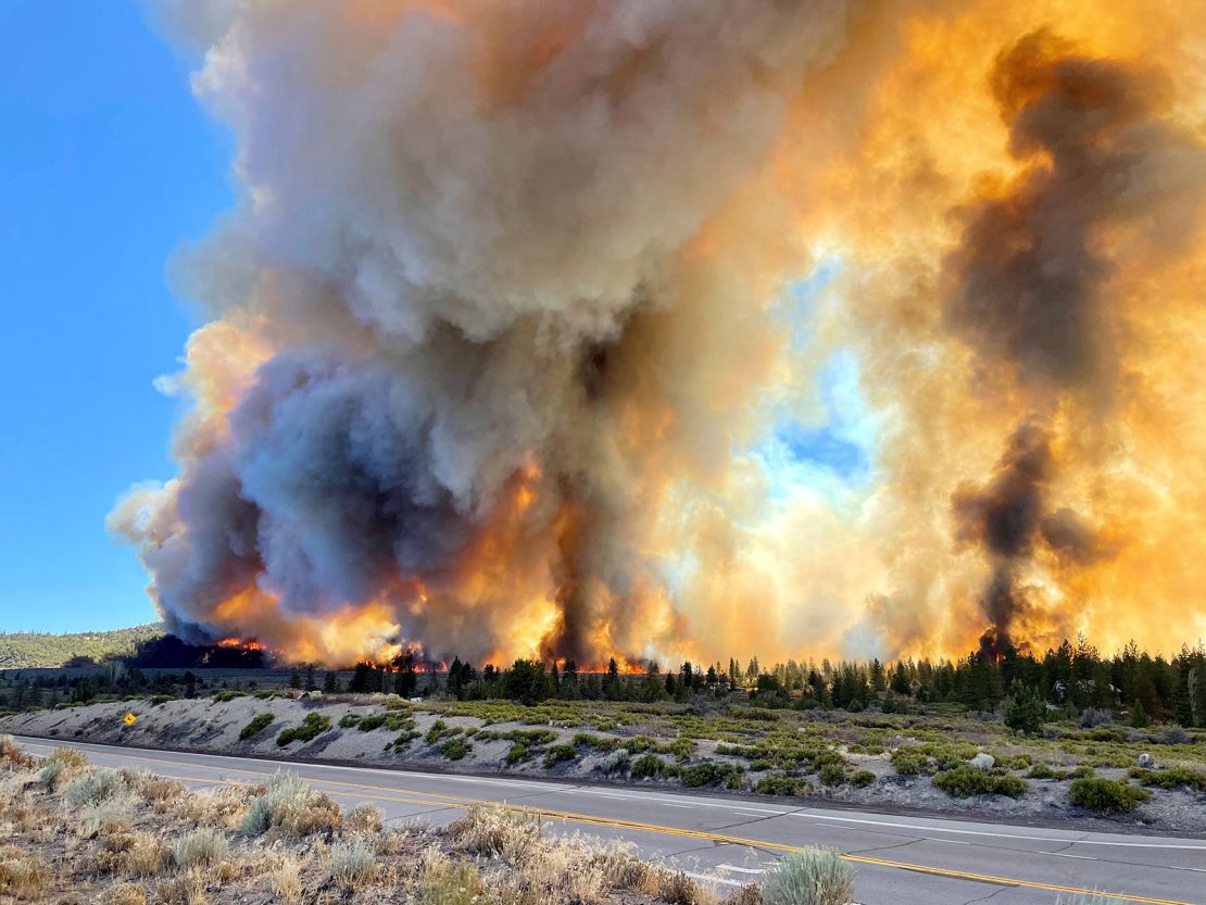 Smoke rises as the Mill Fire burns on the outskirts of Weed, California, Friday.