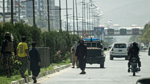 Taliban fighters (C) stand guard along a road near the Russian embassy after the attack on Monday.  