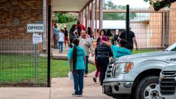 UVALDE, TX-AUG 30: Families arrive at Uvalde Elementary School to visit the new campus and meet faculty members on Monday, Aug. 30, 2022 in Uvalde, TX. Jalissa, 9, was in the cafeteria of Robb Elementary when a shooter came into the school and opened fire, killing 19 students and 2 teachers. Jalissa has struggled with nightmares in the months since the shooting and expressed nervousness about going back to school. (Sergio Flores for The Washington Post via Getty Images)