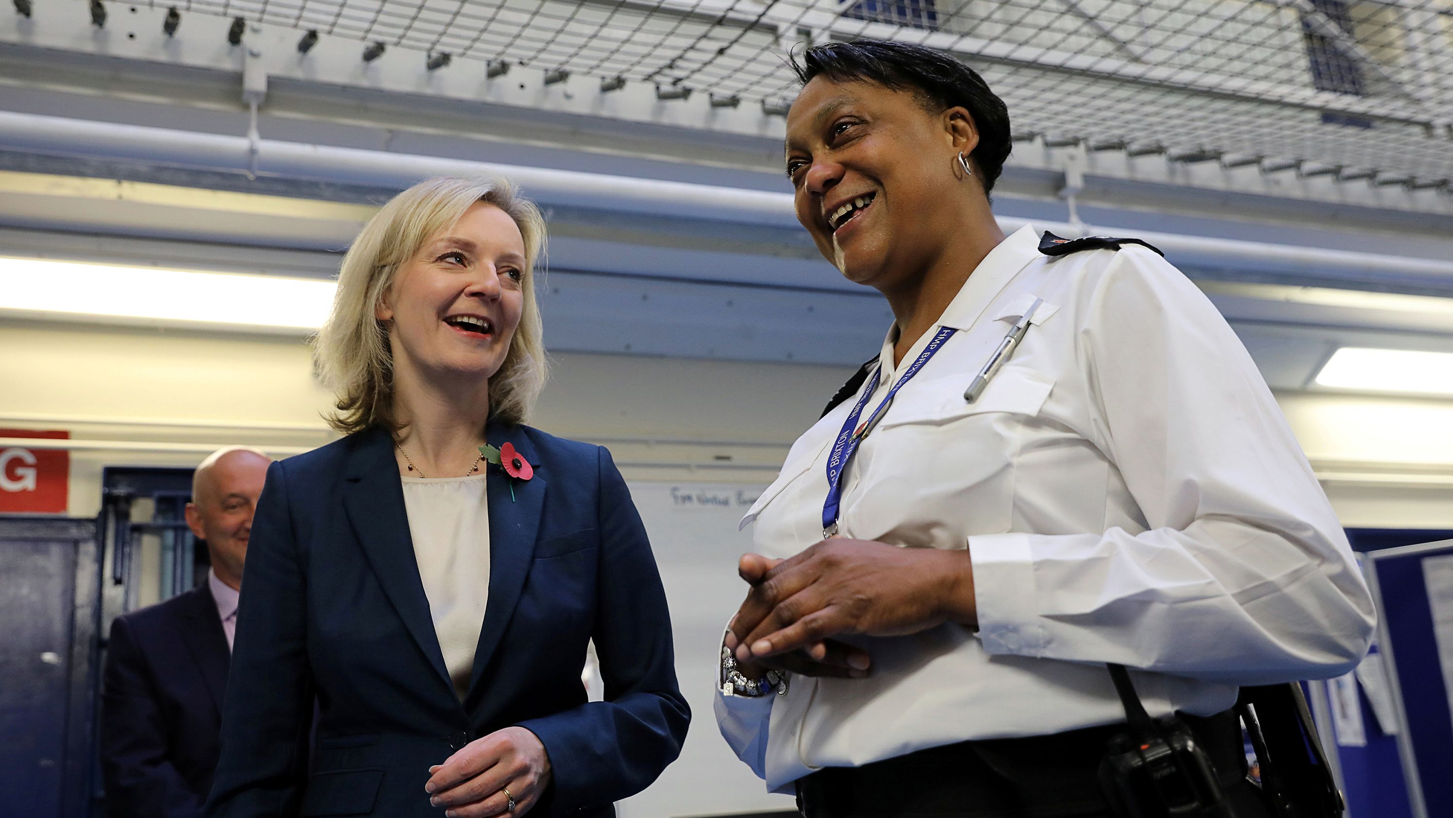 Truss speaks with Custodial Manager Wendy-Fisher McFarlane as she is escorted around the HM Prison Brixton in November 2016.