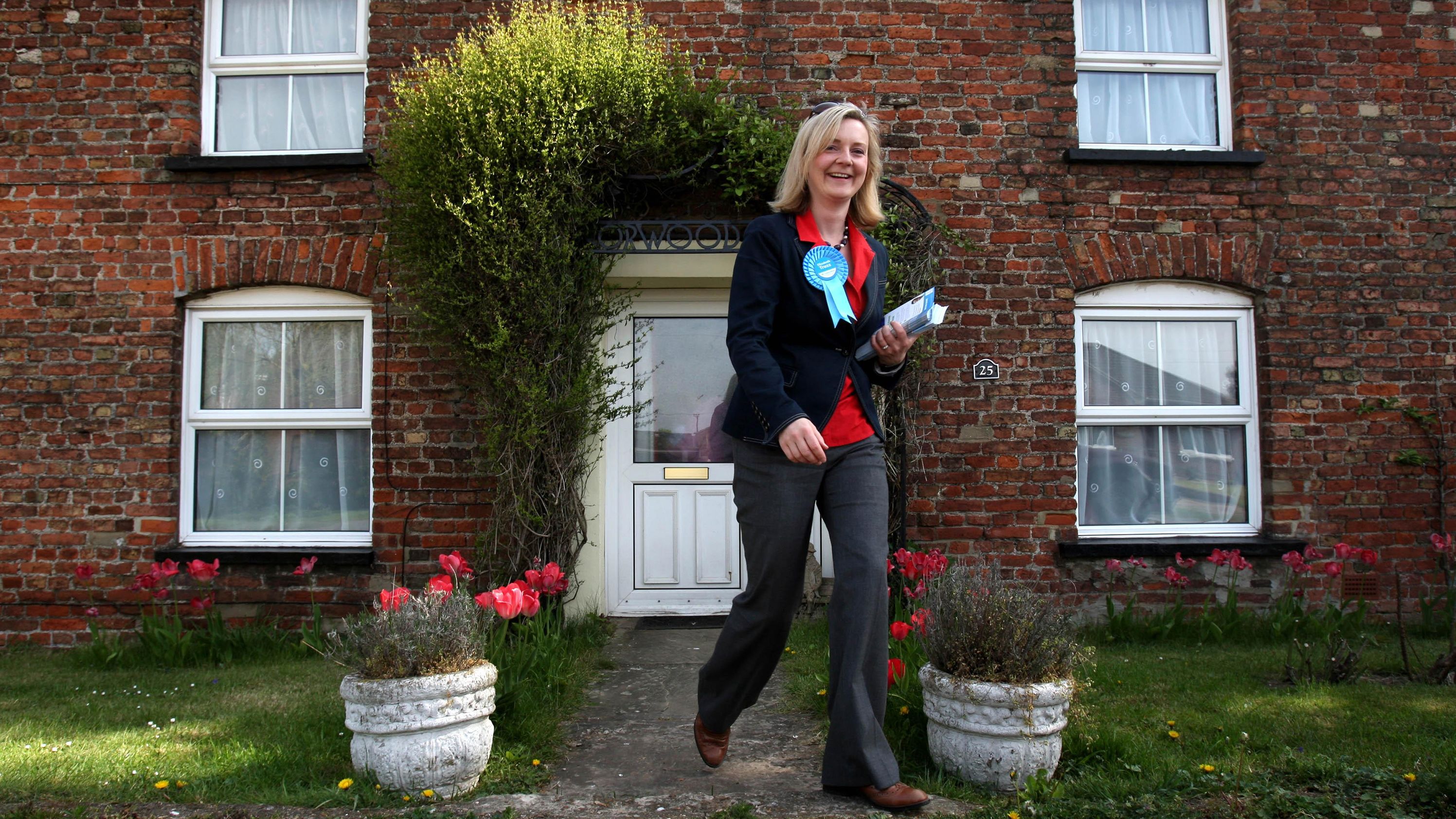 While running for Parliament, Truss canvasses in the village of West Walton in 2010. She was elected later that year. Truss was born in 1975 into a family that she herself has described as "to the left of Labour," Britain's main left-wing party. She grew up in parts of the UK that didn't traditionally vote Conservative, moving between Scotland and the north of England.