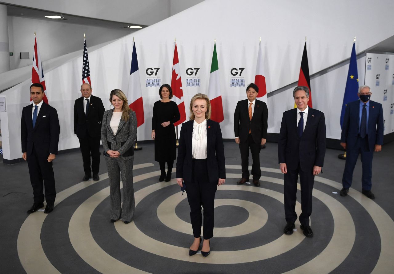 Truss, center, poses for a group photo with other G7 foreign ministers ahead of a meeting in Liverpool, England, in December 2021.