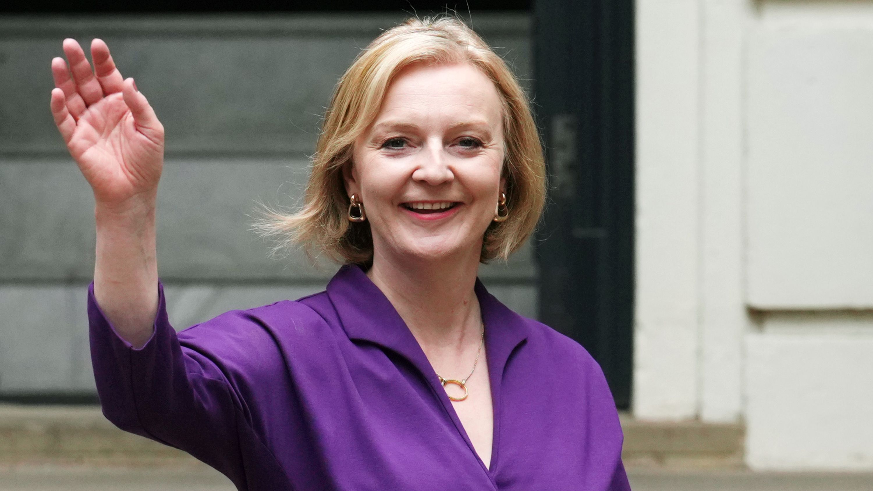 Truss waves as she leaves Conservative Party Headquarters in September 2022.