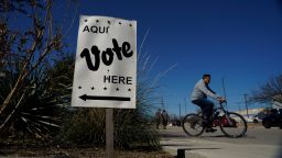 Voters leave an early voting poll site, Monday, Feb. 14, 2022, in San Antonio. Early voting in Texas began Monday.