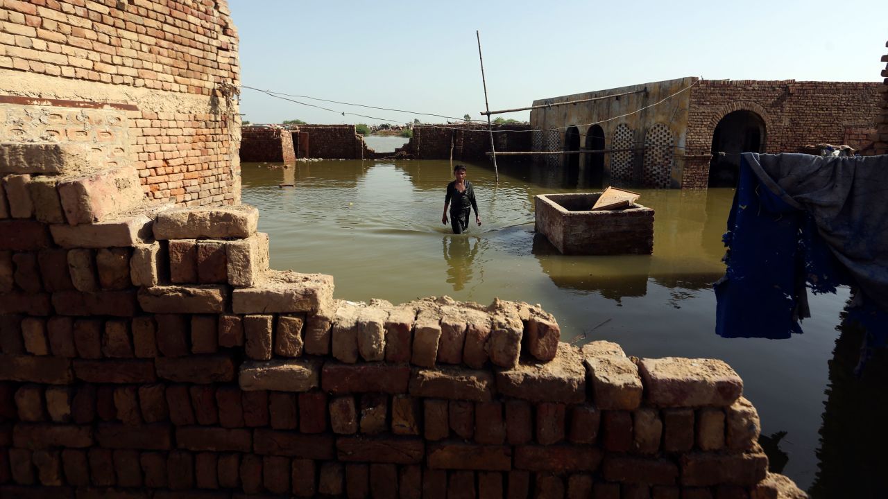 A boy wades through floodwaters from monsoon rains, in Jaffarabad, Pakistan, Monday, Sept. 5, 2022. The U.N. refugee agency rushed in more desperately needed aid Monday to flood-stricken Pakistan as the nation's prime minister traveled to the south where rising waters of Lake Manchar pose a new threat. (AP Photo/Fareed Khan)