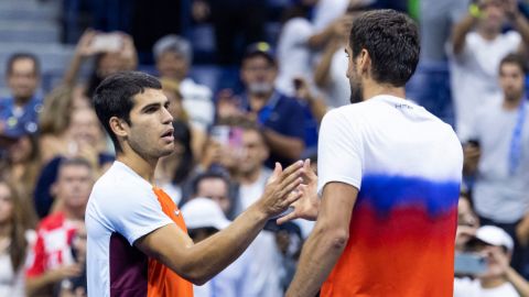 Alcaraz (left) and Cilic (right) shake hands after Tuesday's US Open match.