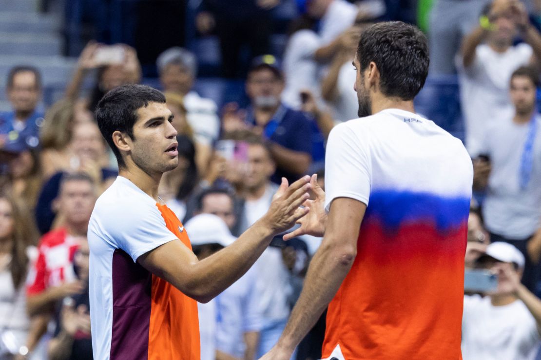 Alcaraz (left) and Cilic (right) shake hands after Tuesday's US Open match.