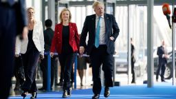 Britain's Prime Minister Boris Johnson (R) and Britain's Foreign Secretary Liz Truss arrive ahead of an extraordinary summit at NATO Headquarters in Brussels on March 24, 2022. (Photo by Evan Vucci / POOL / AFP) (Photo by EVAN VUCCI/POOL/AFP via Getty Images)