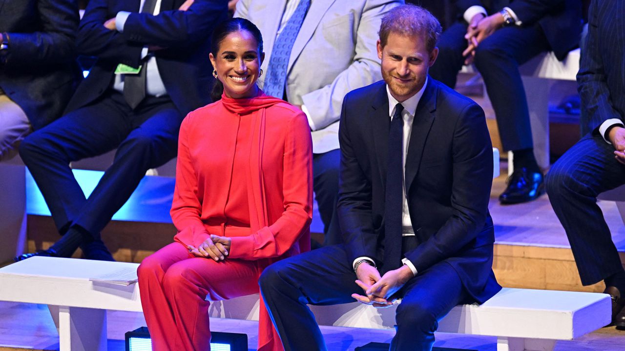 Meghan, Duchess of Sussex and Prince Harry react as they attend the annual One Young World Summit  in Manchester, north-west England on September 5, 2022.
