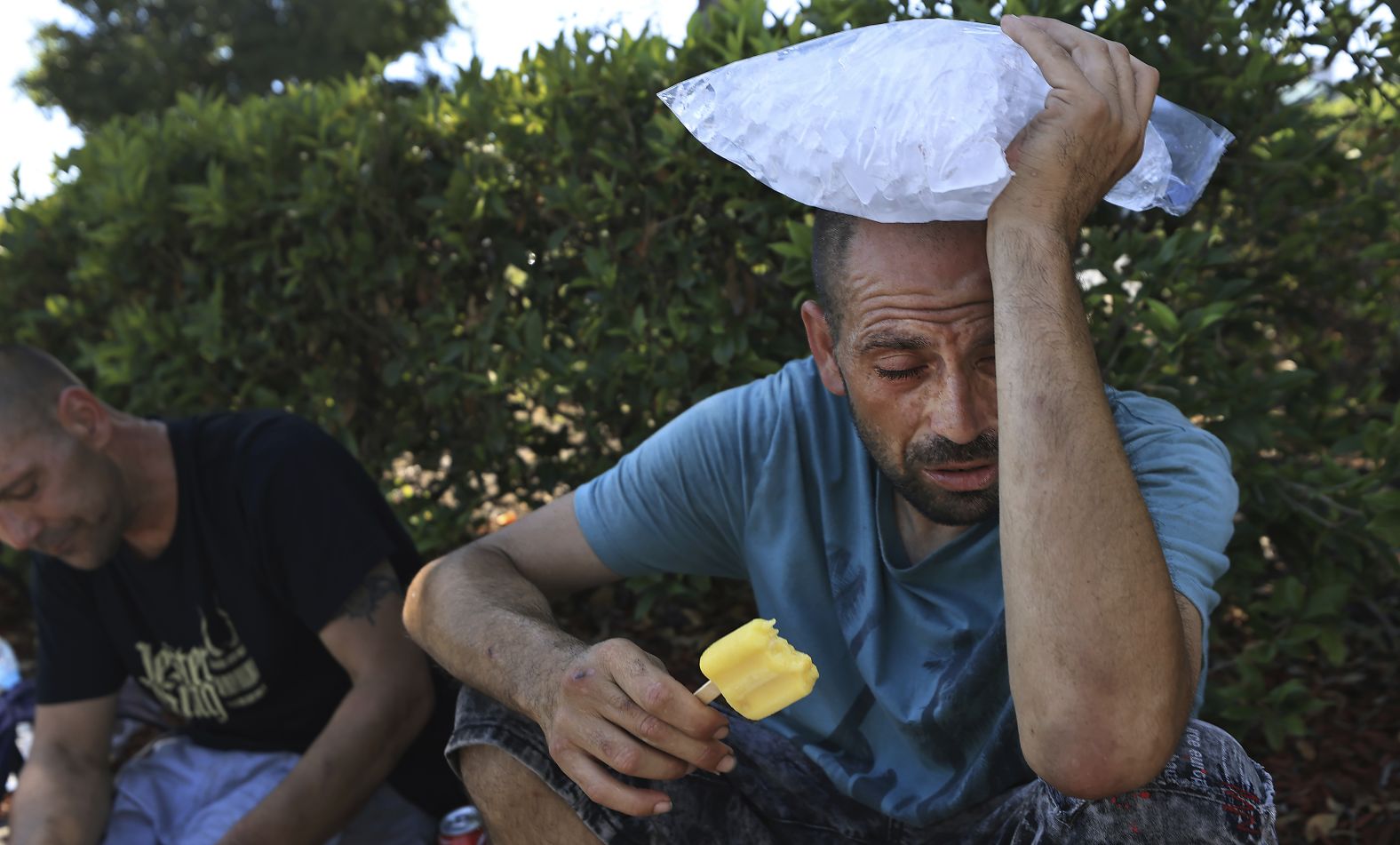 Michael Williams cools off with a bag of ice and a popsicle as the temperature rises in Santa Rosa, California, on Monday, September 5.